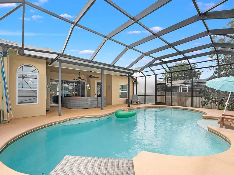 Tropical landscaping around pool in Saint Lucie home