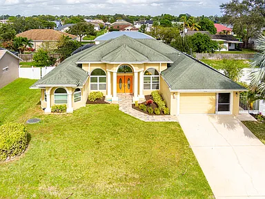 Primary suite in Port St. Lucie home with vaulted ceiling