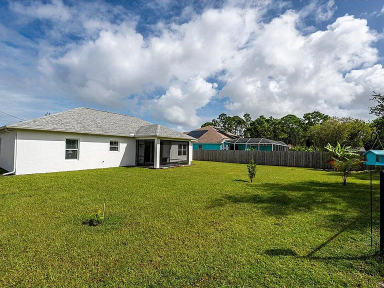 Modern Florida home exterior in Saint Lucie with tropical plants