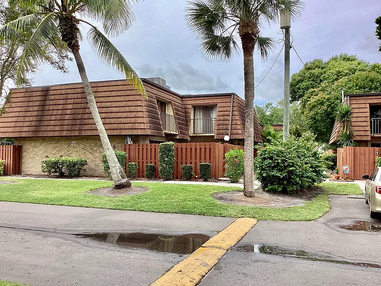 Backyard pool in Port St. Lucie home with screened enclosure