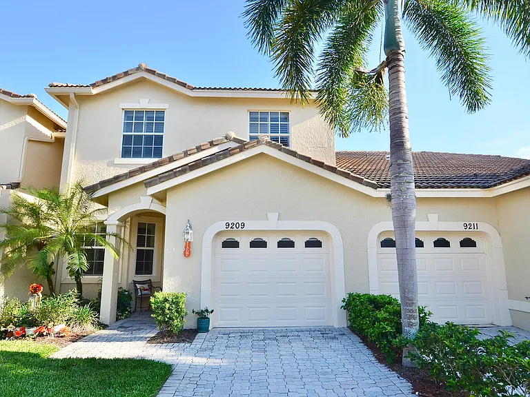 Backyard in Port Saint Lucie home with fire pit and patio